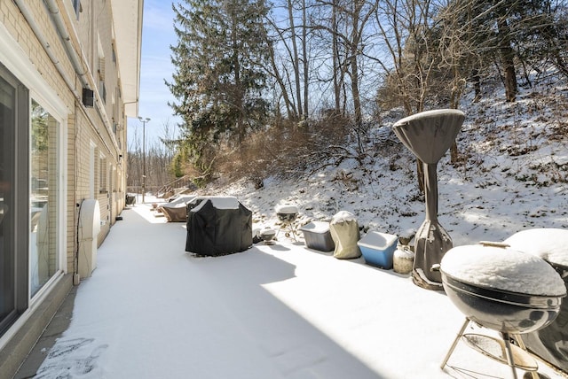 snow covered patio featuring grilling area