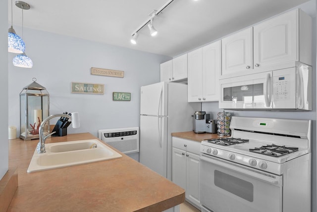 kitchen featuring sink, white cabinets, white appliances, and decorative light fixtures