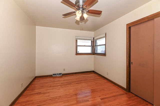 unfurnished bedroom with ceiling fan, a closet, and light hardwood / wood-style flooring