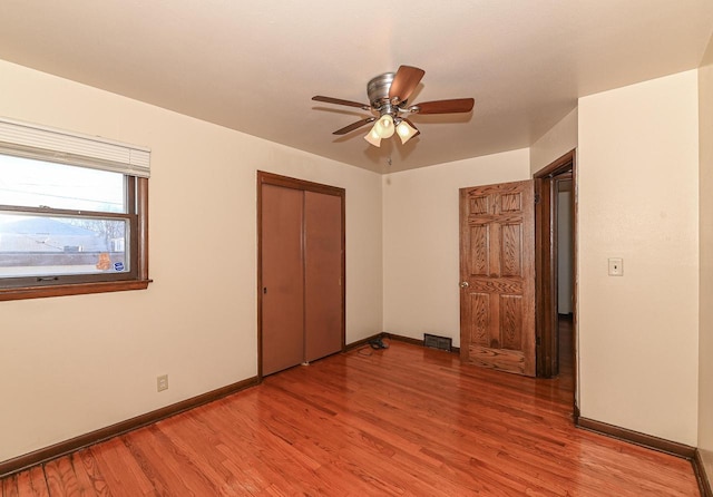 unfurnished bedroom with a closet, ceiling fan, and light hardwood / wood-style flooring