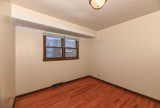 spare room featuring hardwood / wood-style floors