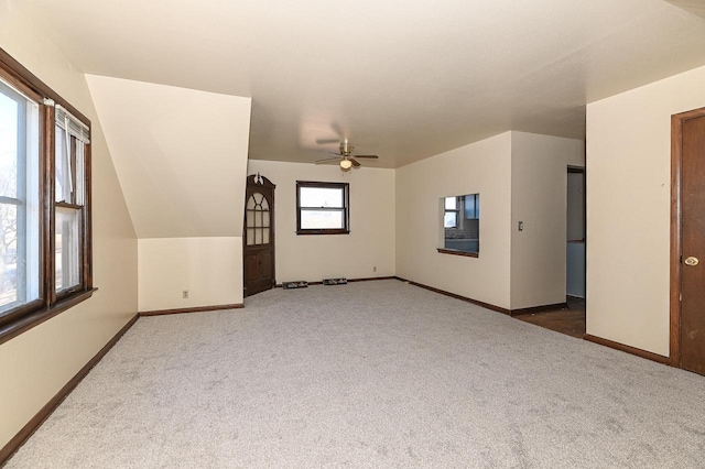 unfurnished room featuring ceiling fan and carpet