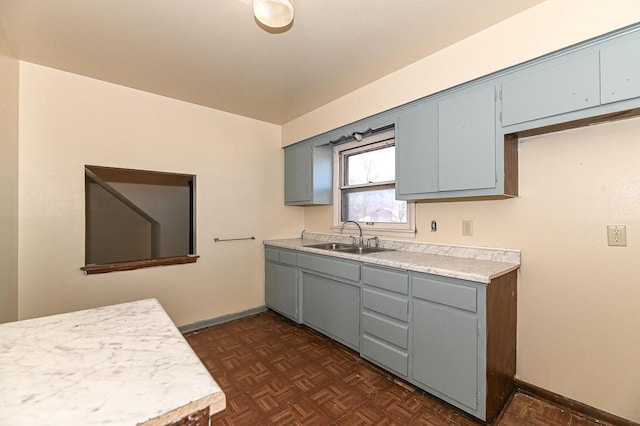 kitchen featuring dark parquet flooring and sink