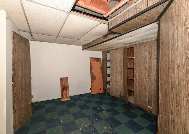 basement featuring a paneled ceiling