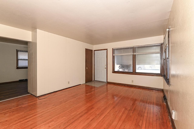 empty room with hardwood / wood-style flooring