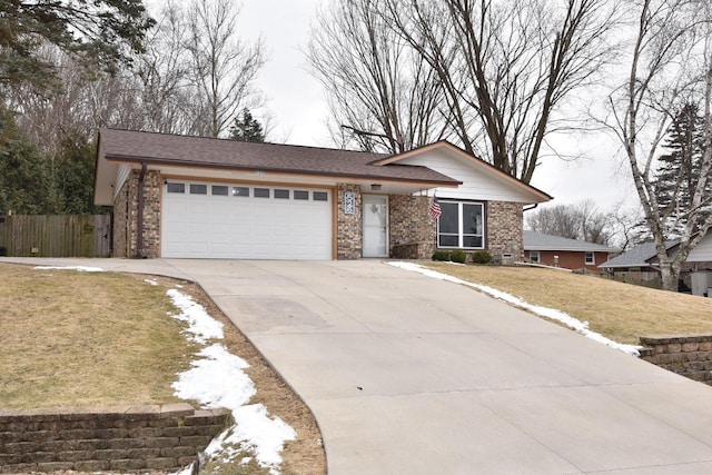 ranch-style house featuring a garage and a front yard