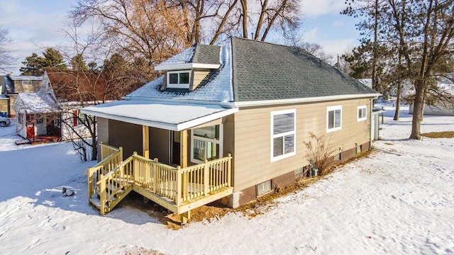 snow covered house with a porch