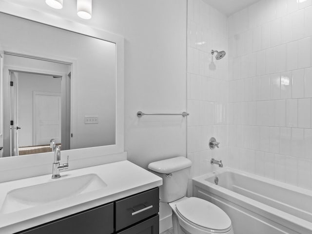 full bathroom with vanity, tiled shower / bath combo, and toilet