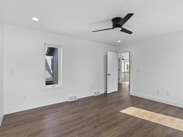 spare room featuring dark hardwood / wood-style floors and ceiling fan