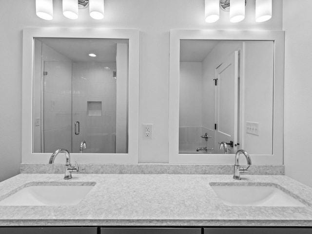 bathroom featuring vanity and a shower with shower door