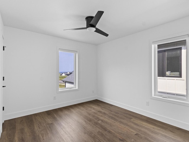 unfurnished room with ceiling fan and dark hardwood / wood-style flooring