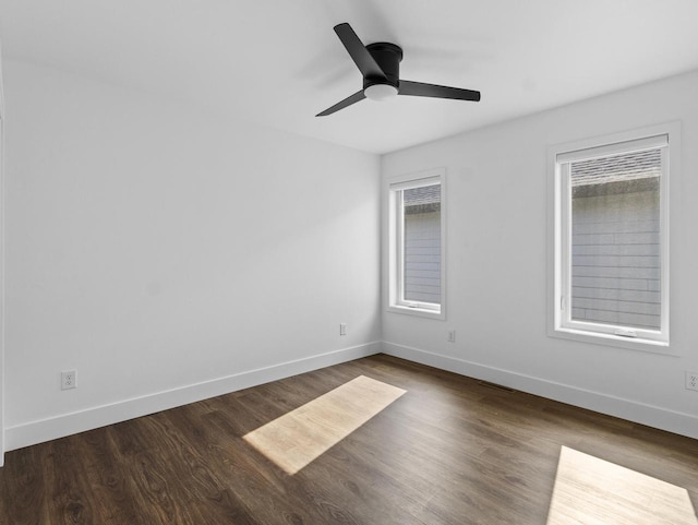 unfurnished room featuring dark wood-type flooring and ceiling fan