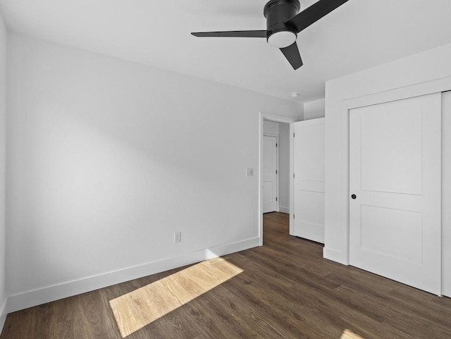 unfurnished bedroom featuring dark hardwood / wood-style flooring, a closet, and ceiling fan