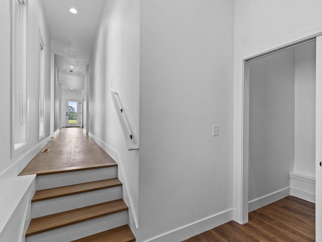 stairway with hardwood / wood-style floors