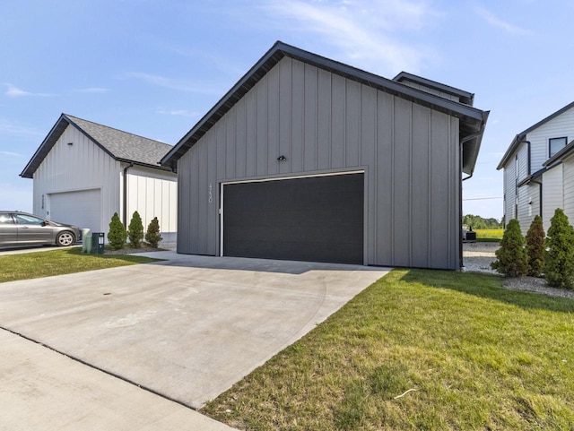 exterior space featuring an outbuilding, a garage, and a front lawn