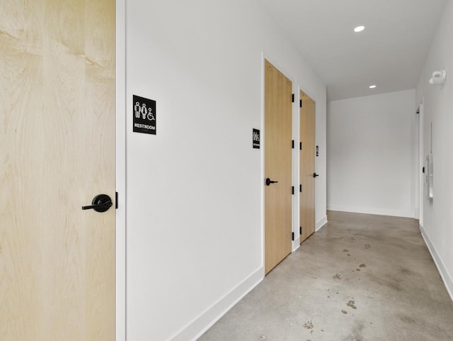 hall featuring concrete flooring