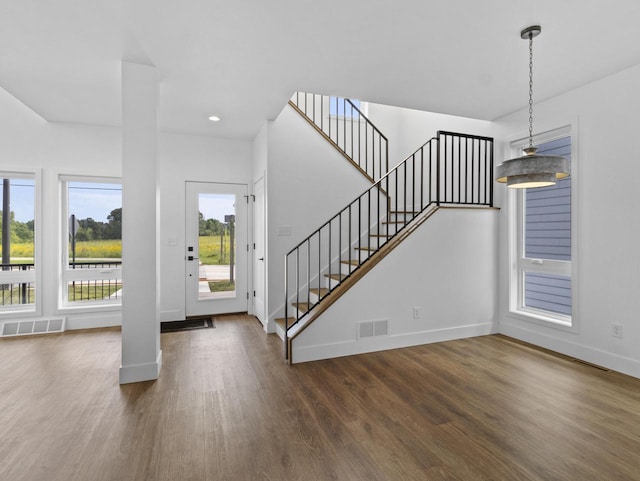 entryway with dark hardwood / wood-style flooring