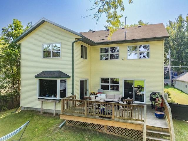 rear view of house with a wooden deck, an outdoor living space, and a lawn