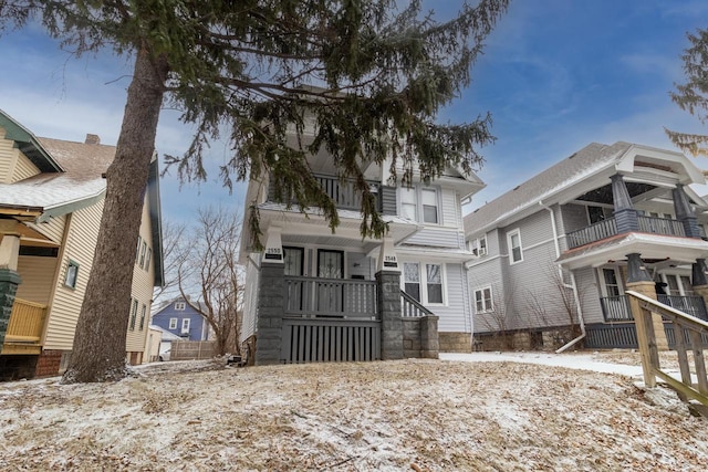 view of snow covered rear of property