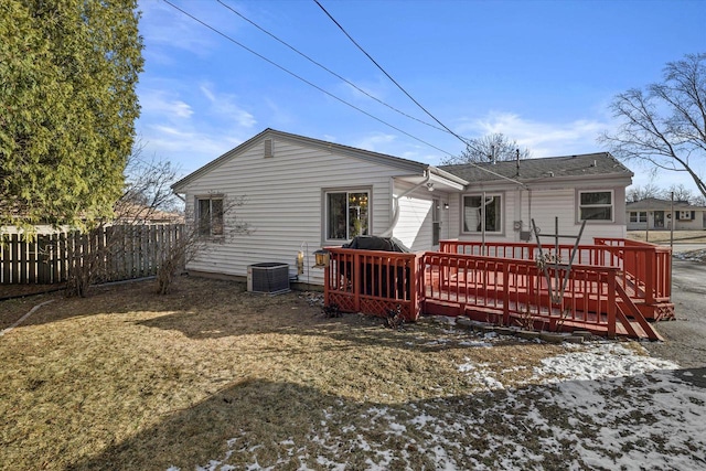 rear view of property featuring a wooden deck and central AC