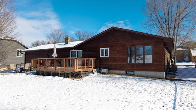 snow covered property featuring a deck