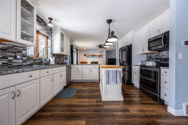 kitchen with dark hardwood / wood-style flooring, wood counters, white cabinets, and appliances with stainless steel finishes