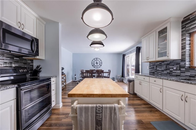 kitchen featuring stainless steel appliances, wooden counters, and white cabinets