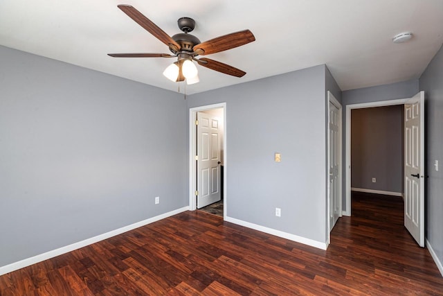 unfurnished bedroom featuring dark hardwood / wood-style floors and ceiling fan