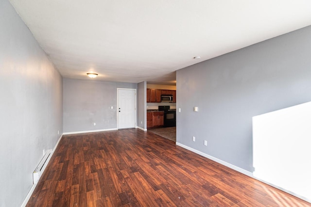 unfurnished living room with dark wood-type flooring and a baseboard radiator