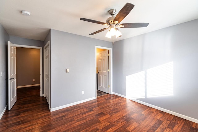 unfurnished bedroom featuring dark hardwood / wood-style flooring and ceiling fan