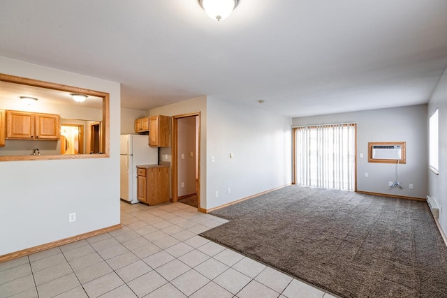 unfurnished living room with baseboard heating, light colored carpet, and a wall mounted air conditioner