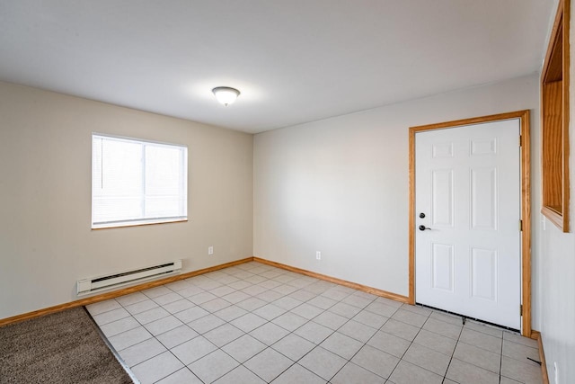 tiled empty room featuring a baseboard radiator