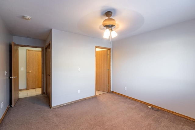 unfurnished bedroom featuring ceiling fan and carpet