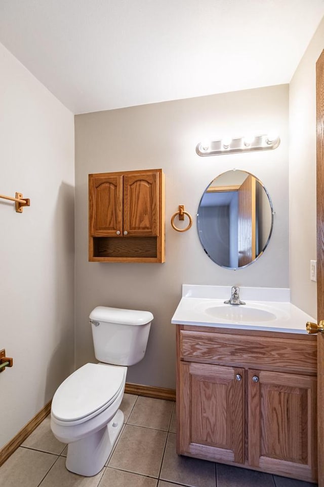 bathroom featuring vanity, tile patterned floors, and toilet