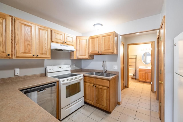 kitchen with sink, stainless steel dishwasher, light tile patterned floors, light brown cabinets, and electric stove