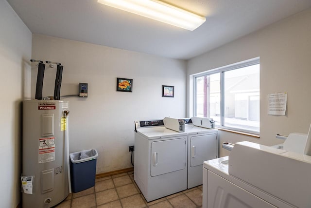 laundry room featuring water heater, separate washer and dryer, and light tile patterned floors