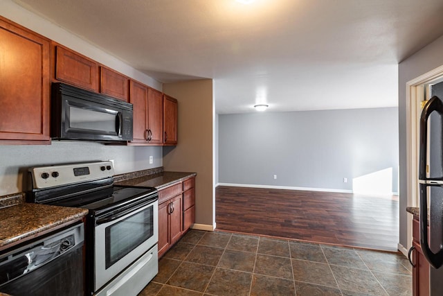 kitchen featuring dark stone countertops and black appliances