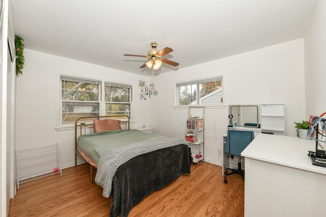 bedroom with ceiling fan and light wood-type flooring