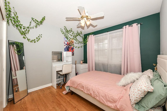 bedroom with ceiling fan and light hardwood / wood-style floors