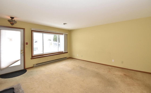 interior space featuring light colored carpet and a baseboard heating unit