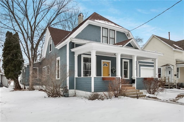 view of front facade featuring a garage and a porch