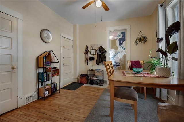 dining area with ceiling fan and light hardwood / wood-style floors