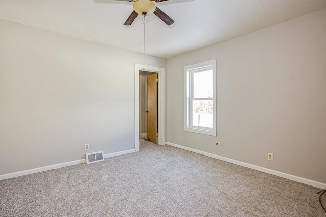 carpeted empty room featuring ceiling fan