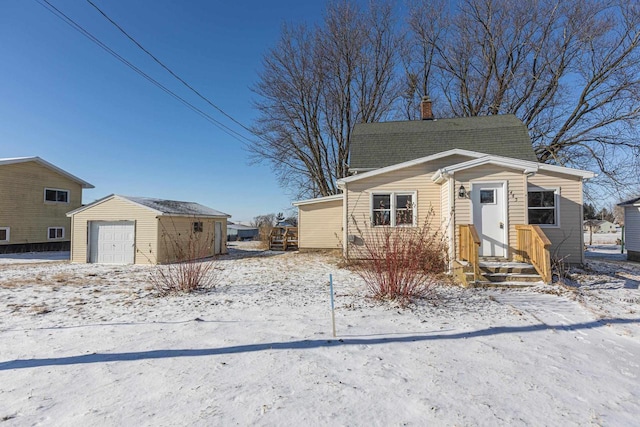 bungalow with an outbuilding and a garage