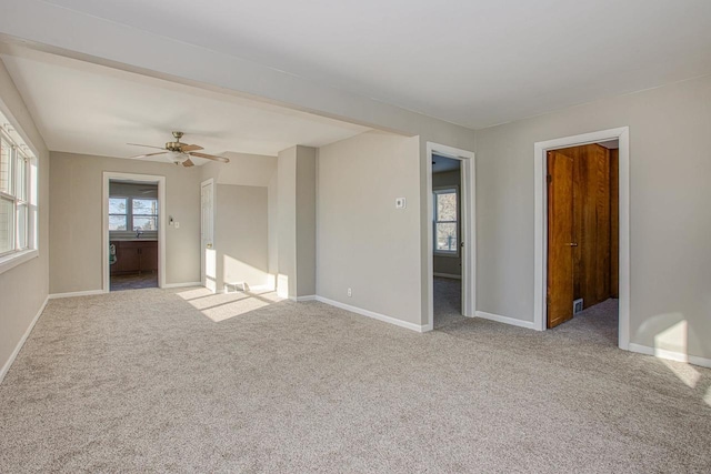 unfurnished room featuring ceiling fan and light colored carpet