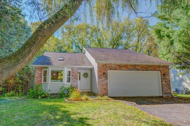 single story home featuring a garage and a front yard