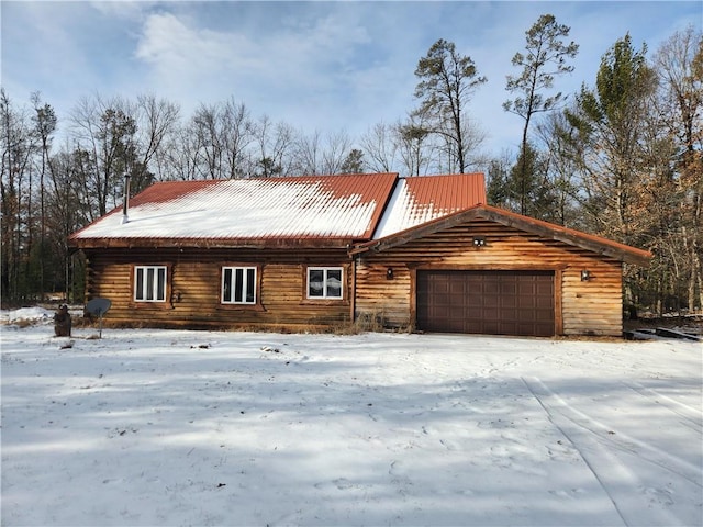 view of front of home featuring an attached garage and metal roof