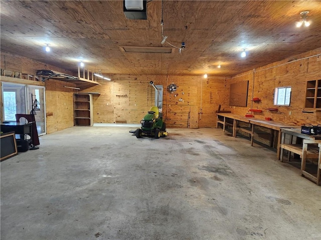 garage featuring wooden ceiling, a workshop area, and a garage door opener