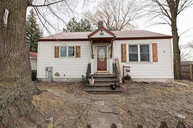 bungalow-style house with central air condition unit