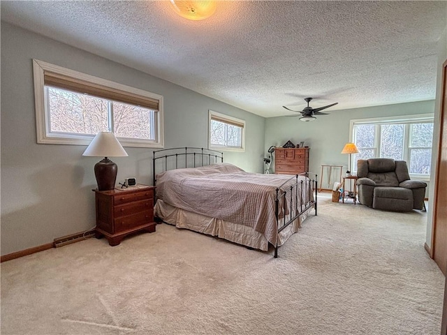 carpeted bedroom with a textured ceiling and ceiling fan